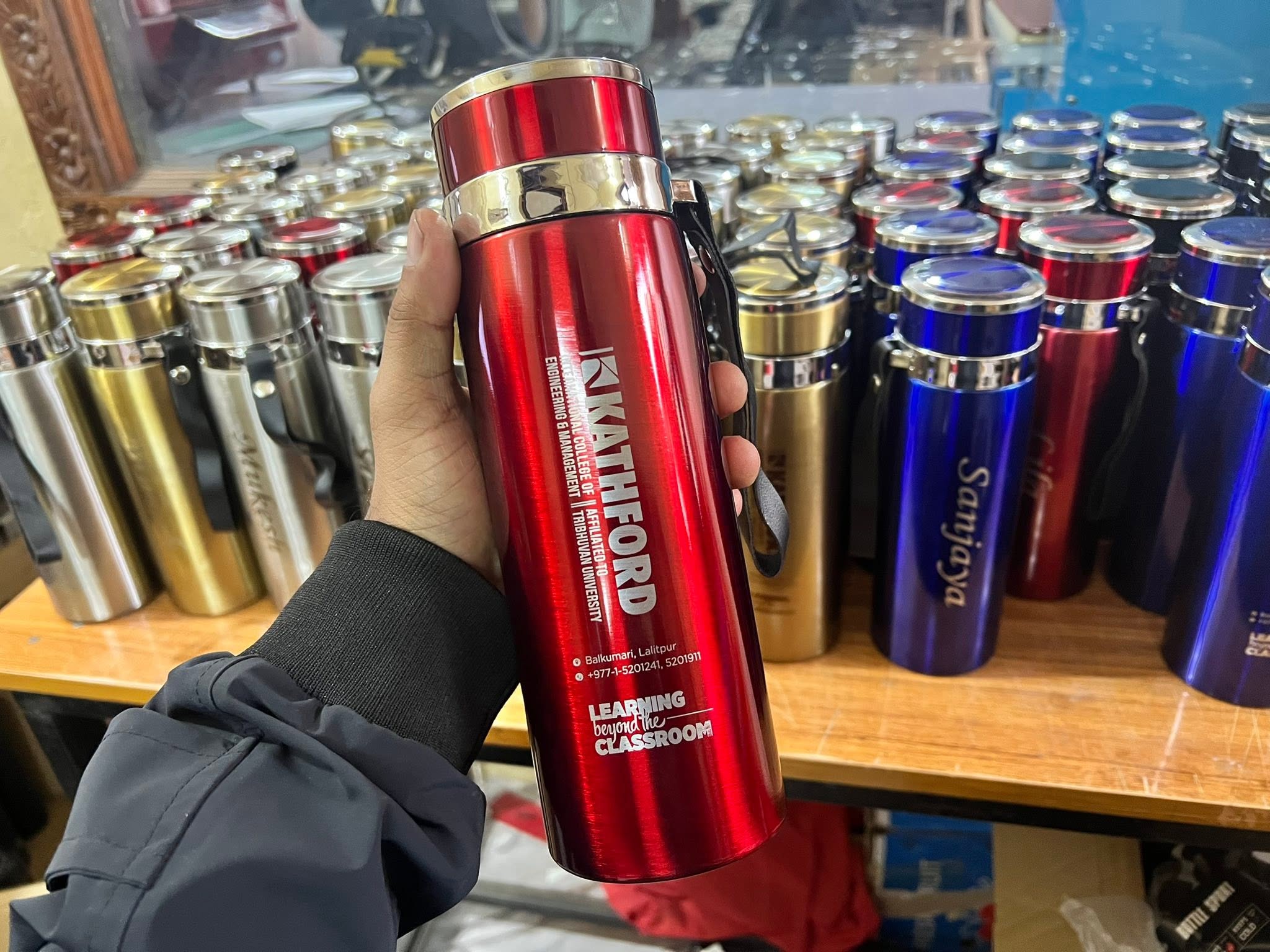 Engraved corporate thermos held in store